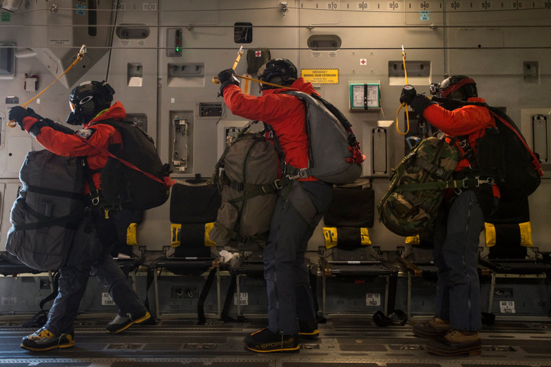 Illustration for article titled Check Out These Shots Of A C-17 Dropping Pararescuemen Over The Navy's Arctic OutpostÂ